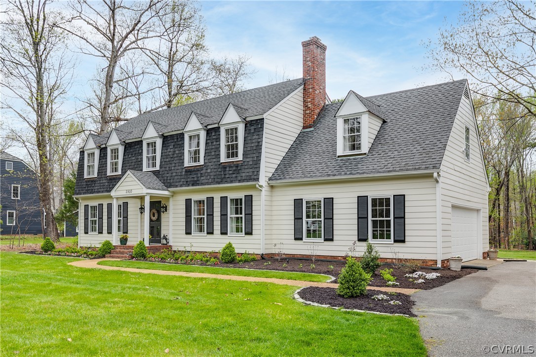2910 East Brigstock Road Midlothian, VA 23113 - Photo 2 of 45 a front view of a house with a garden and yard