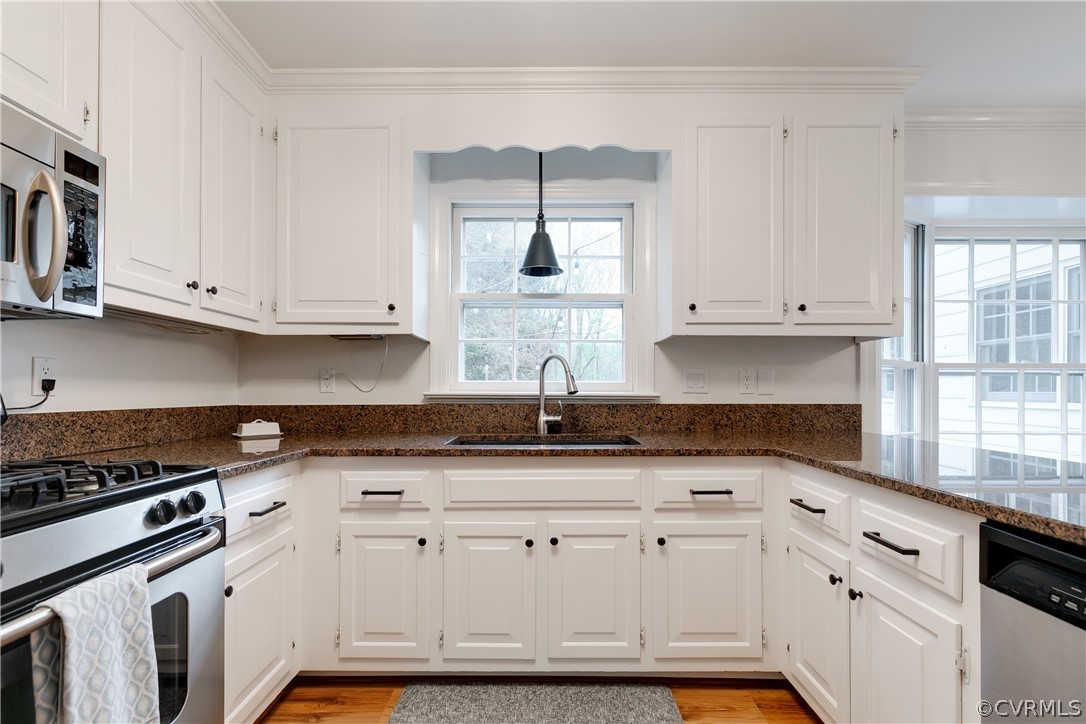 2910 East Brigstock Road Midlothian, VA 23113 - Photo 22 of 45 a kitchen with granite countertop white cabinets and sink