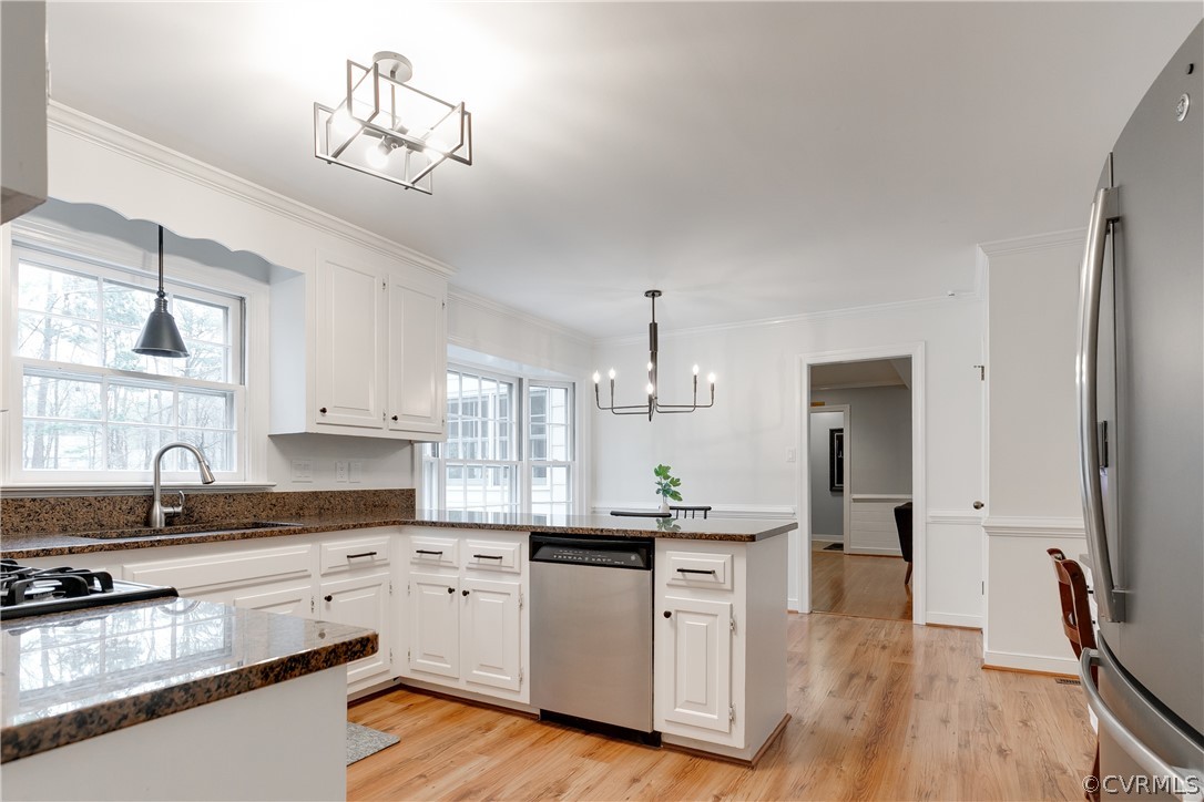 2910 East Brigstock Road Midlothian, VA 23113 - Photo 24 of 45 a kitchen with granite countertop white cabinets and stainless steel appliances