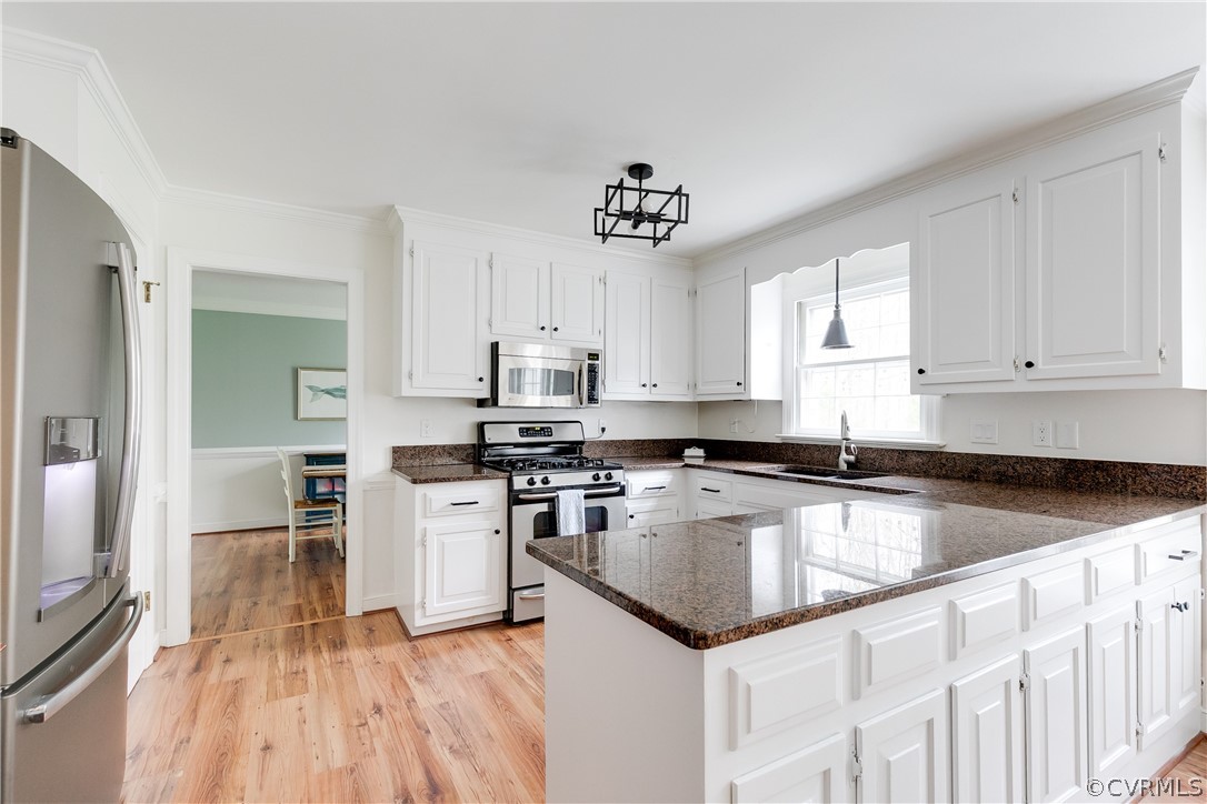 2910 East Brigstock Road Midlothian, VA 23113 - Photo 29 of 45 a kitchen with a center island wooden floor and stainless steel appliances