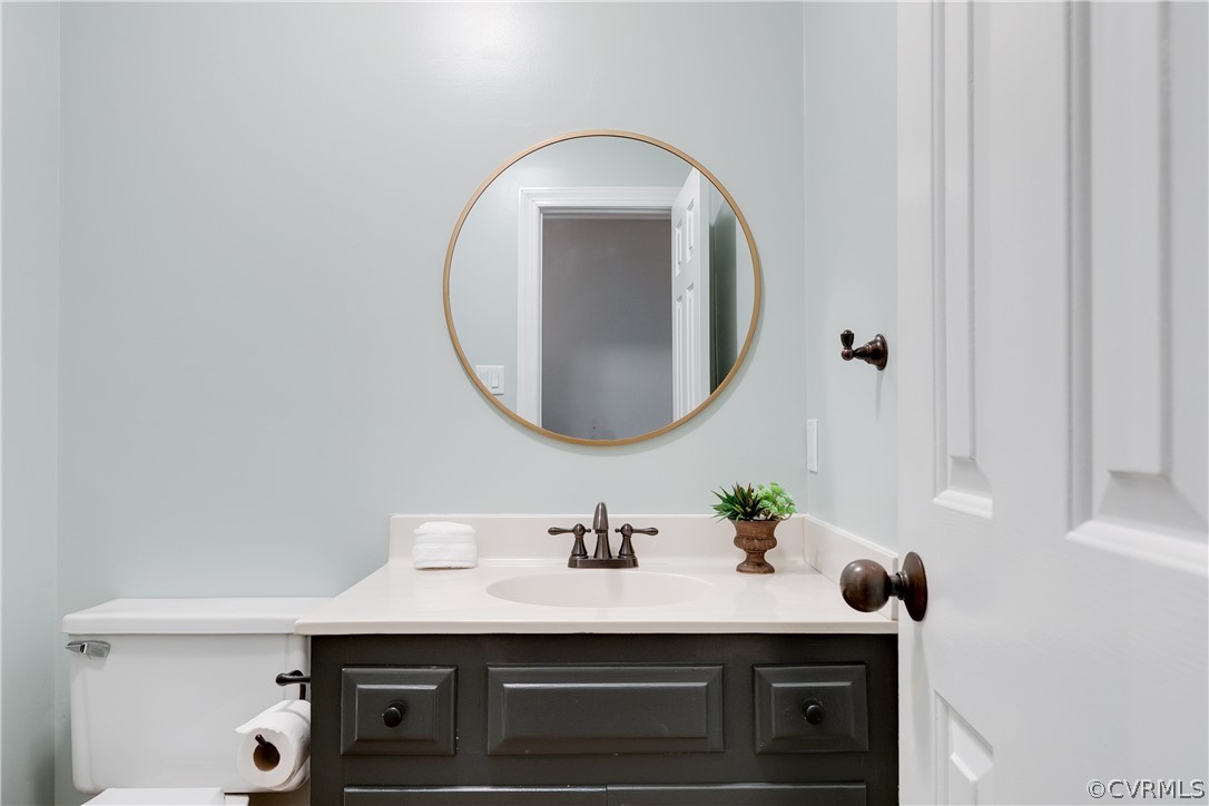 2910 East Brigstock Road Midlothian, VA 23113 - Photo 30 of 45 a bathroom with a sink a vanity and a mirror