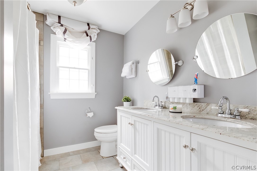 2910 East Brigstock Road Midlothian, VA 23113 - Photo 36 of 45 a bathroom with a double vanity sink and a mirror