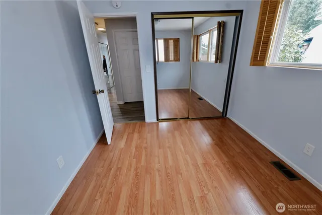 a view of a hallway view with wooden floor and staircase