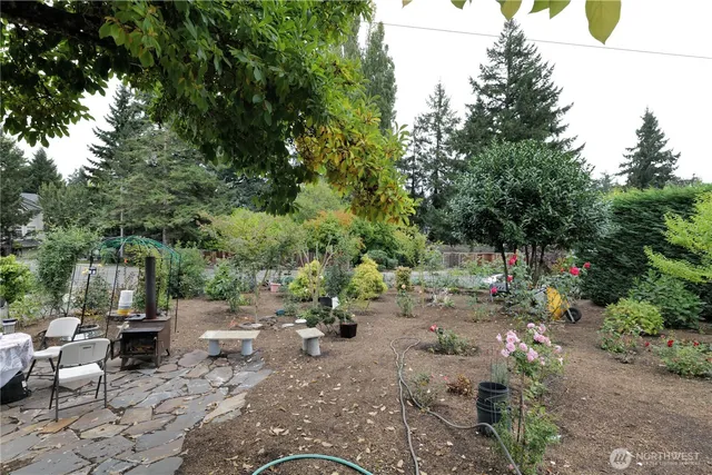 a view of backyard with a table and chairs