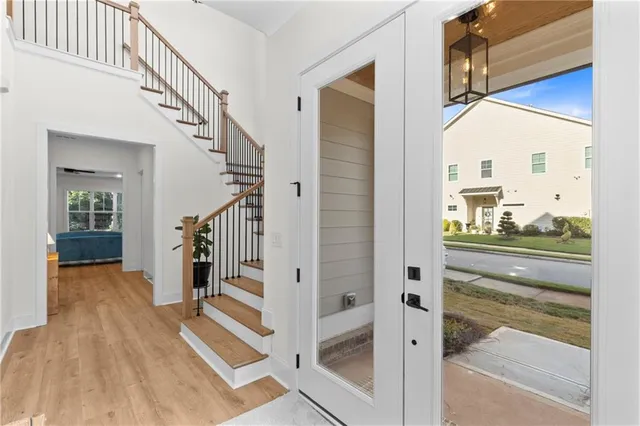 a view of a hallway with wooden floor and staircase
