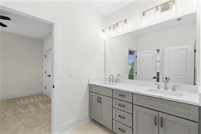 a bathroom with a double vanity sink and mirror