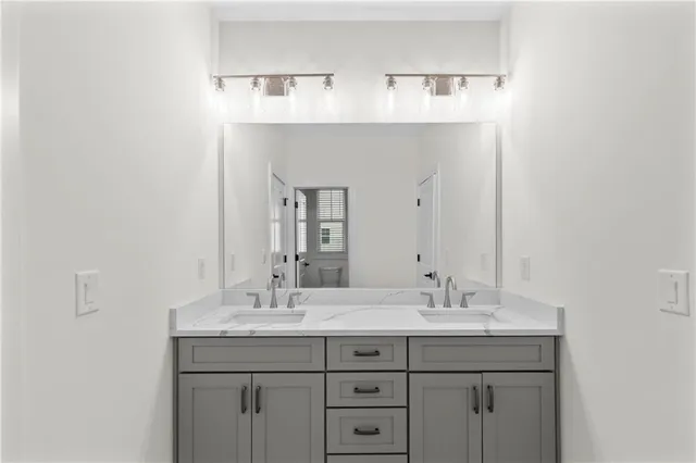 a bathroom with a double vanity sink and a mirror