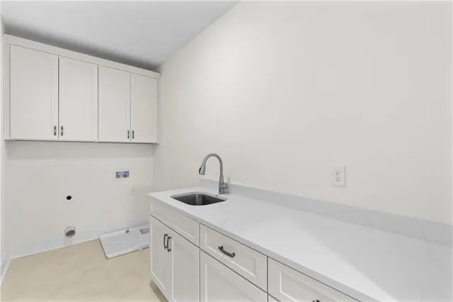 a view of a kitchen with white cabinets