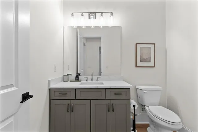 a bathroom with a toilet a sink and mirror