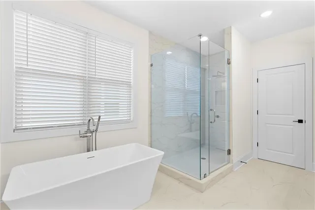 a bathroom with a bathtub and a shower