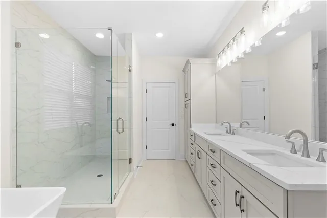 a spacious bathroom with a double vanity sink mirror double and shower