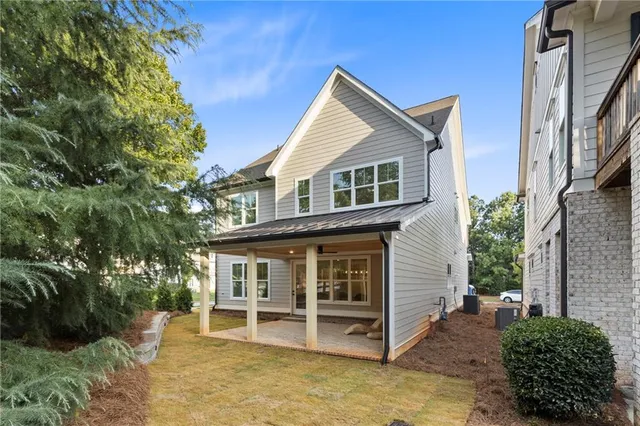 a view of a house with a yard balcony and furniture