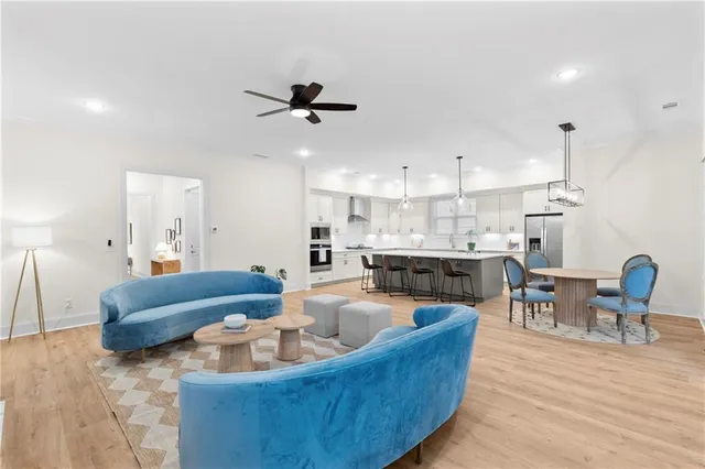 a living room with furniture and kitchen view