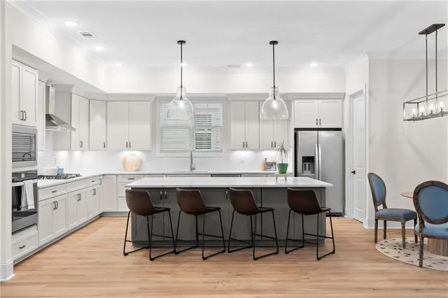 a large kitchen with a table and chairs