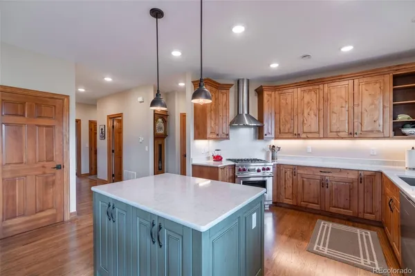 a kitchen with stainless steel appliances granite countertop a sink a stove and a refrigerator