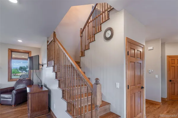 a view of entryway and hall with wooden floor