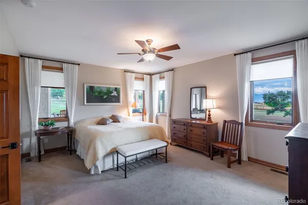 a bedroom with a bed chair and a window