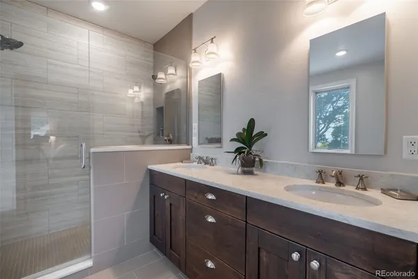 a bathroom with a double vanity sink and a mirror