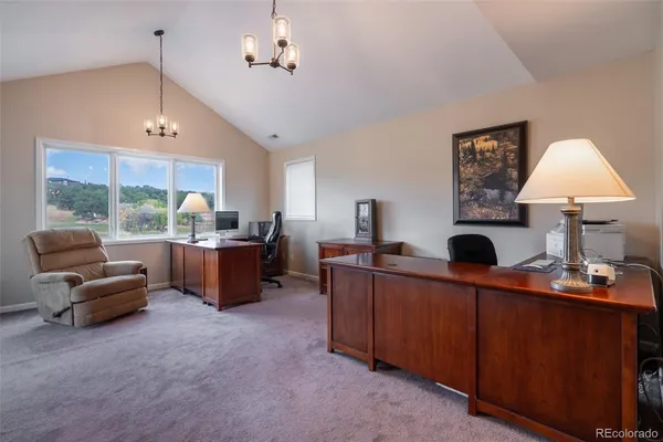 a room with furniture a bed and a chandelier