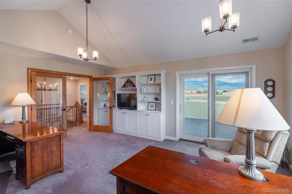 a living room with furniture a lamp and a chandelier