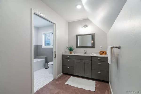 a spacious bathroom with a double vanity sink and a mirror