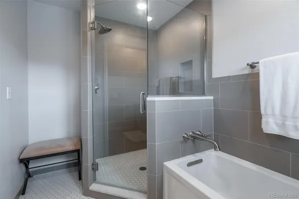 a bathroom with a bathtub and a shower
