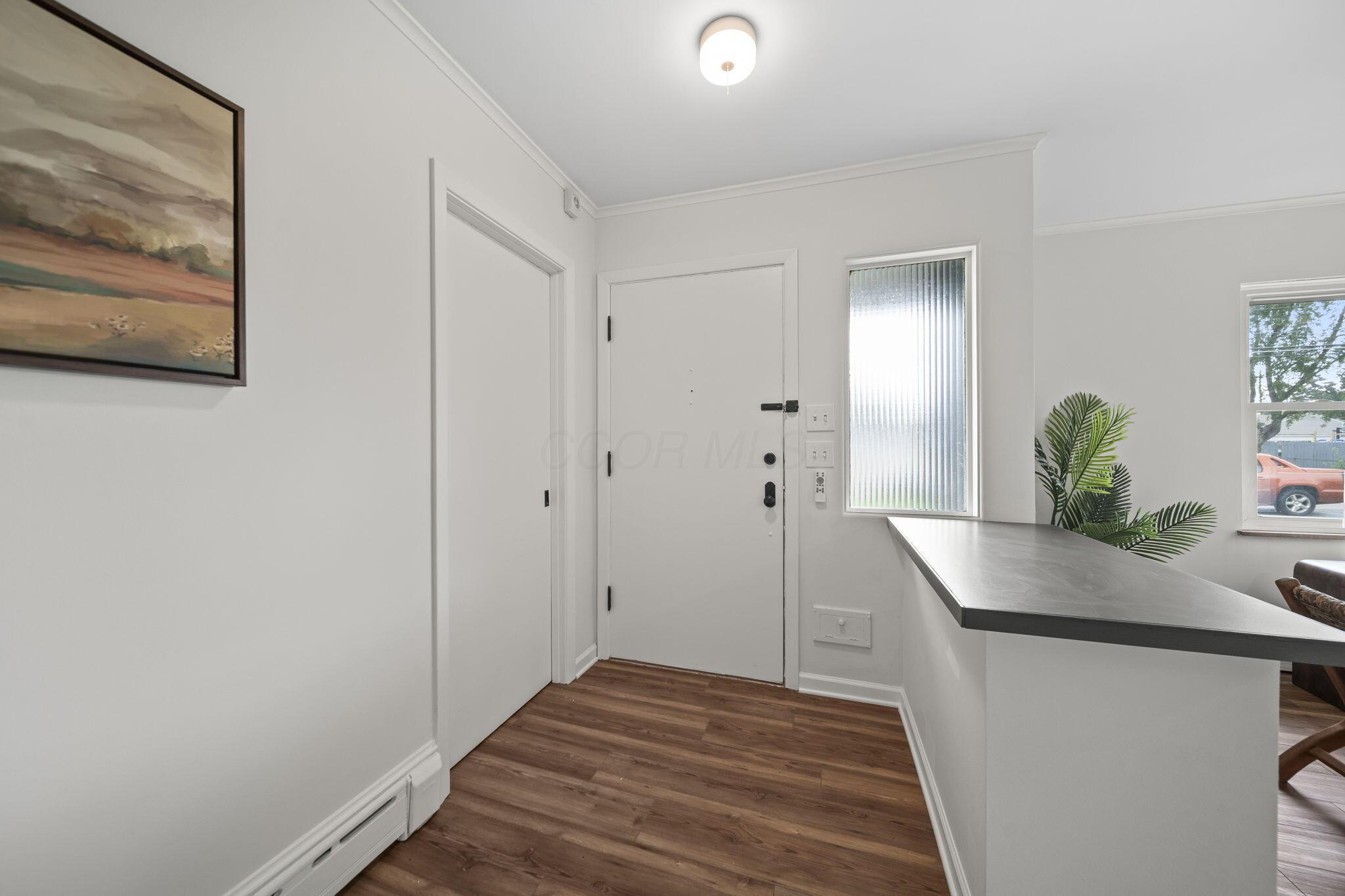 New LVP flooring, alabaster walls, and a fluted privacy window