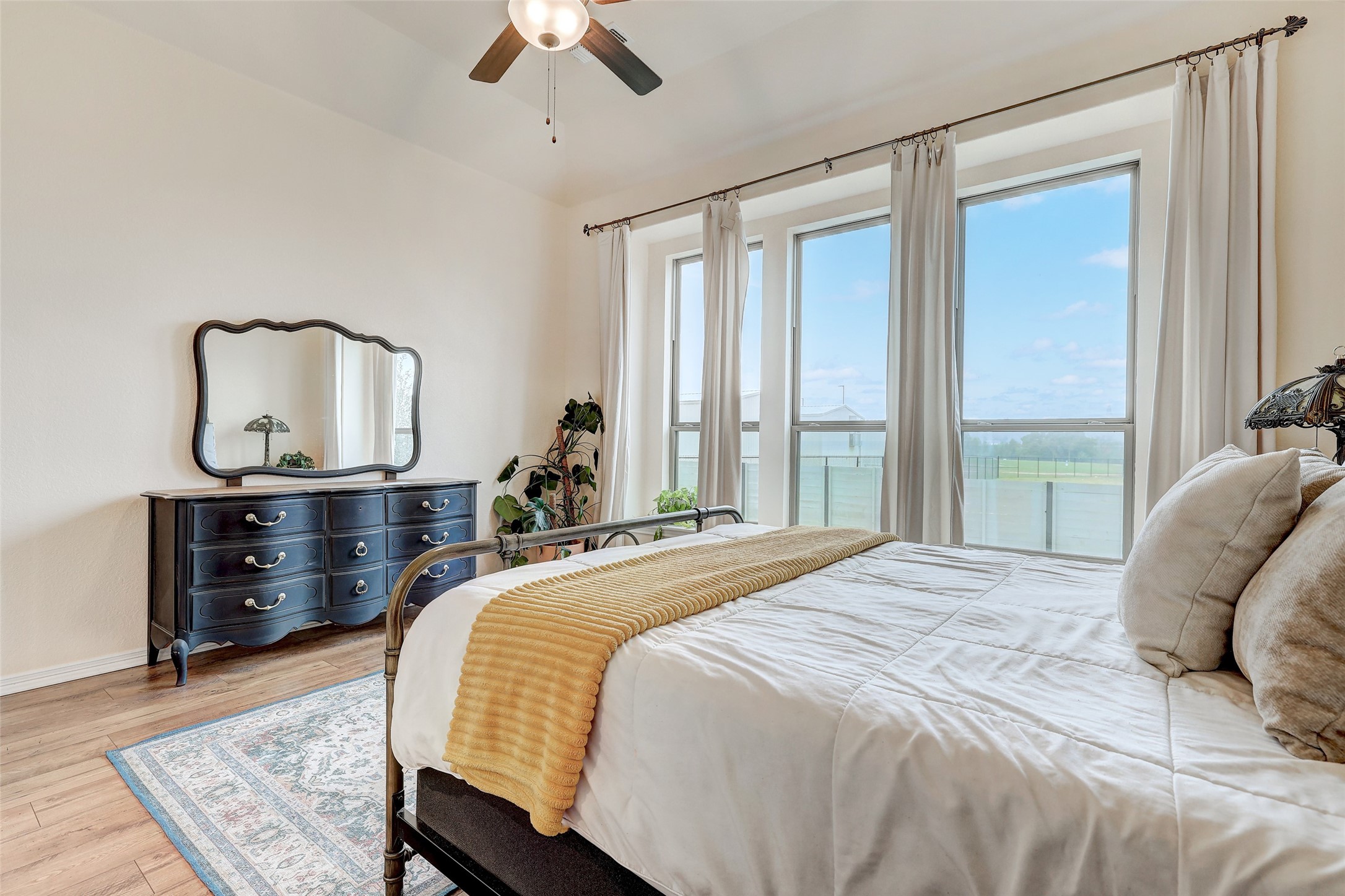 1117 Spring Gulch Lane Georgetown, TX 78628 - Photo 20 of 39 Tall windows and ample flooring create an inviting bedroom sanctuary with expansive views.