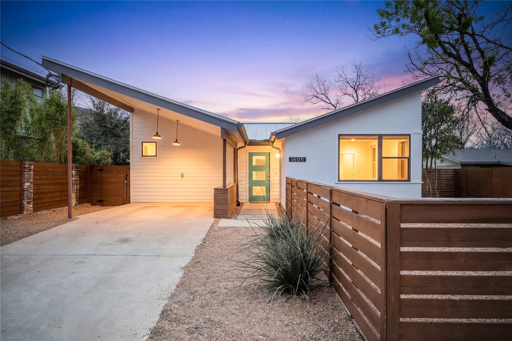 View of front of home featuring an attached carport and driveway