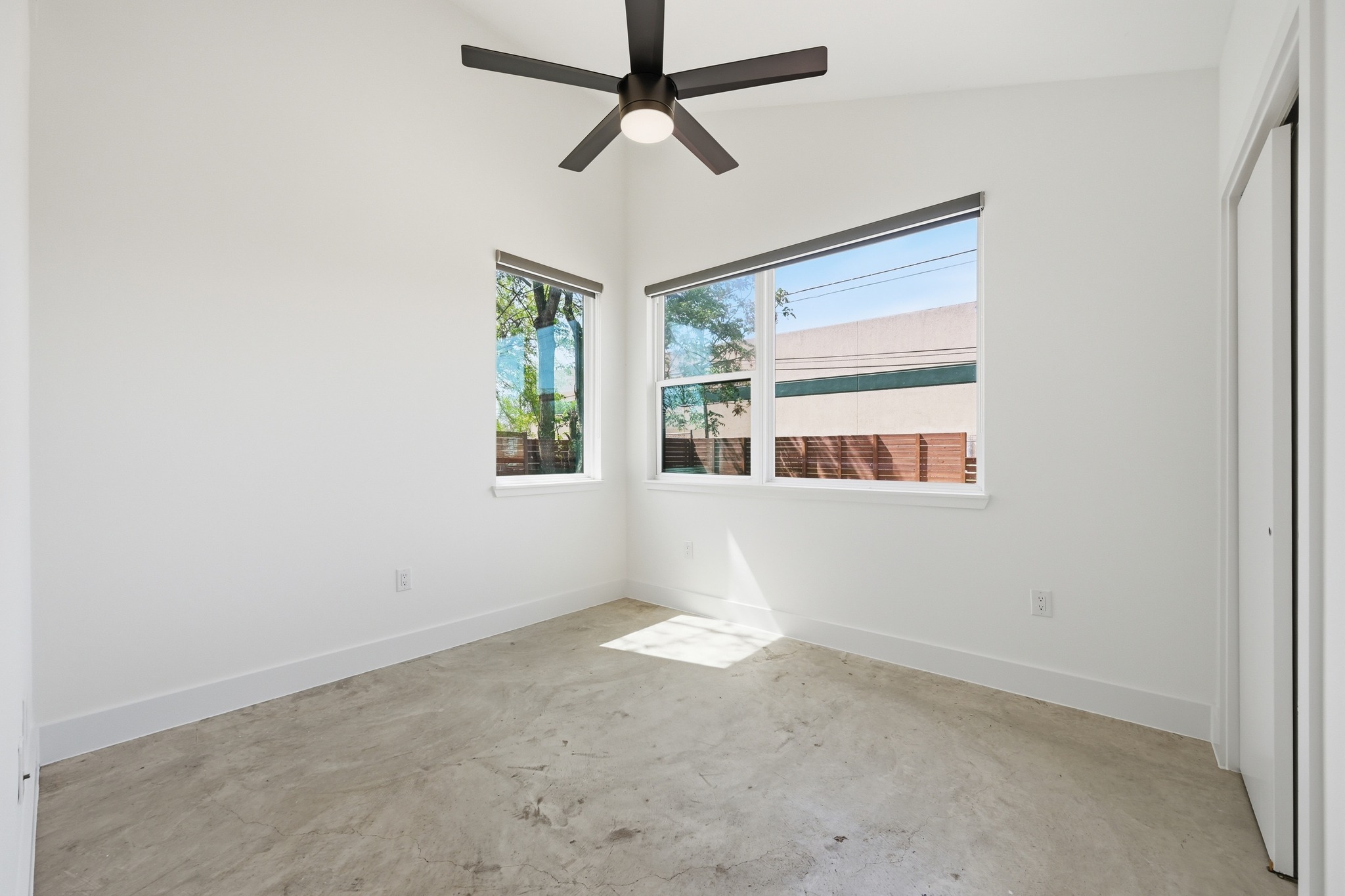 1805 Tillery Street Austin, TX 78721 - Photo 15 of 23 Unfurnished bedroom featuring concrete flooring, a closet, a ceiling fan, and lofted ceiling