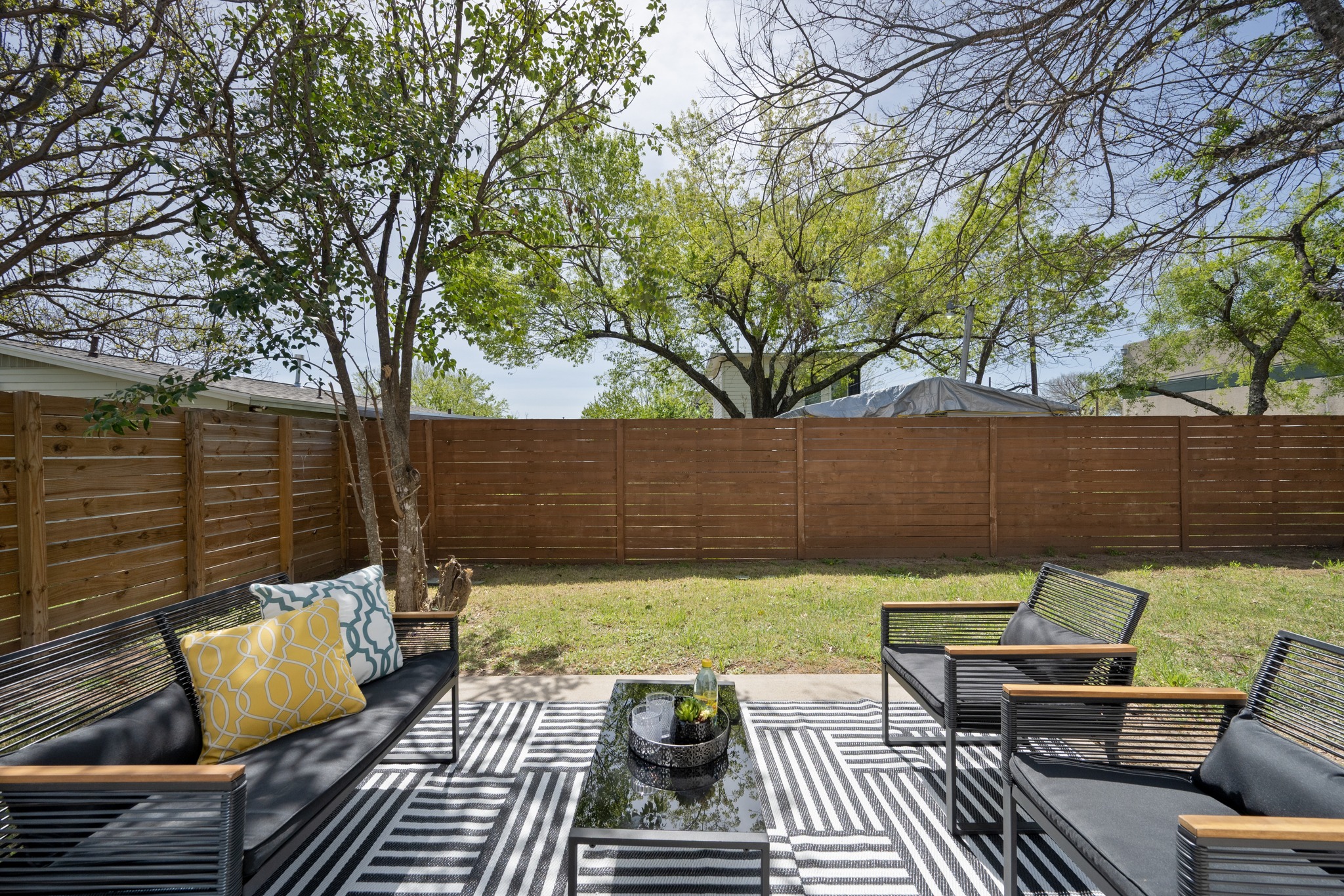 1805 Tillery Street Austin, TX 78721 - Photo 18 of 23 Fenced backyard featuring an outdoor living space and a patio area