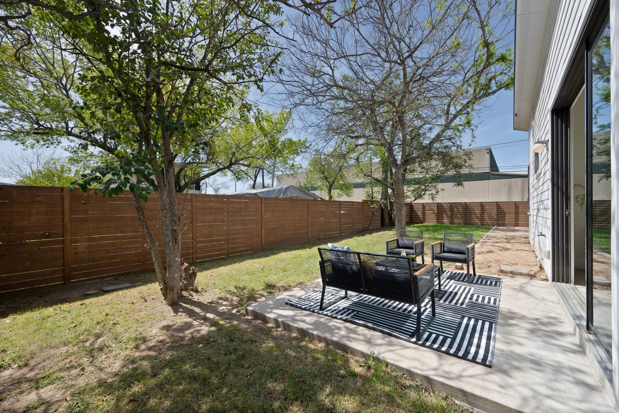 1805 Tillery Street Austin, TX 78721 - Photo 20 of 23 Fenced backyard with a patio area and an outdoor living space