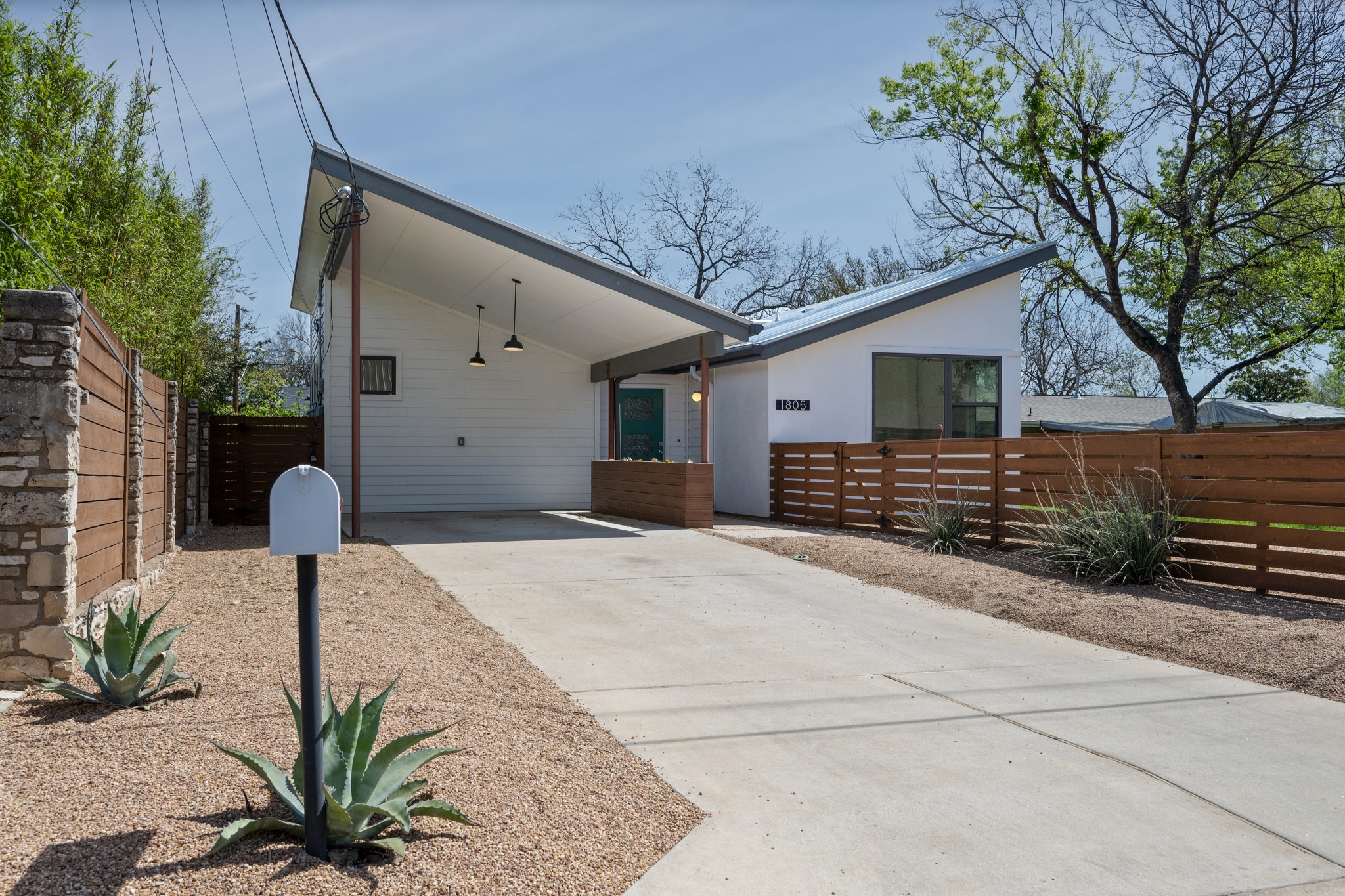 1805 Tillery Street Austin, TX 78721 - Photo 22 of 23 View of front of property featuring concrete driveway and a carport