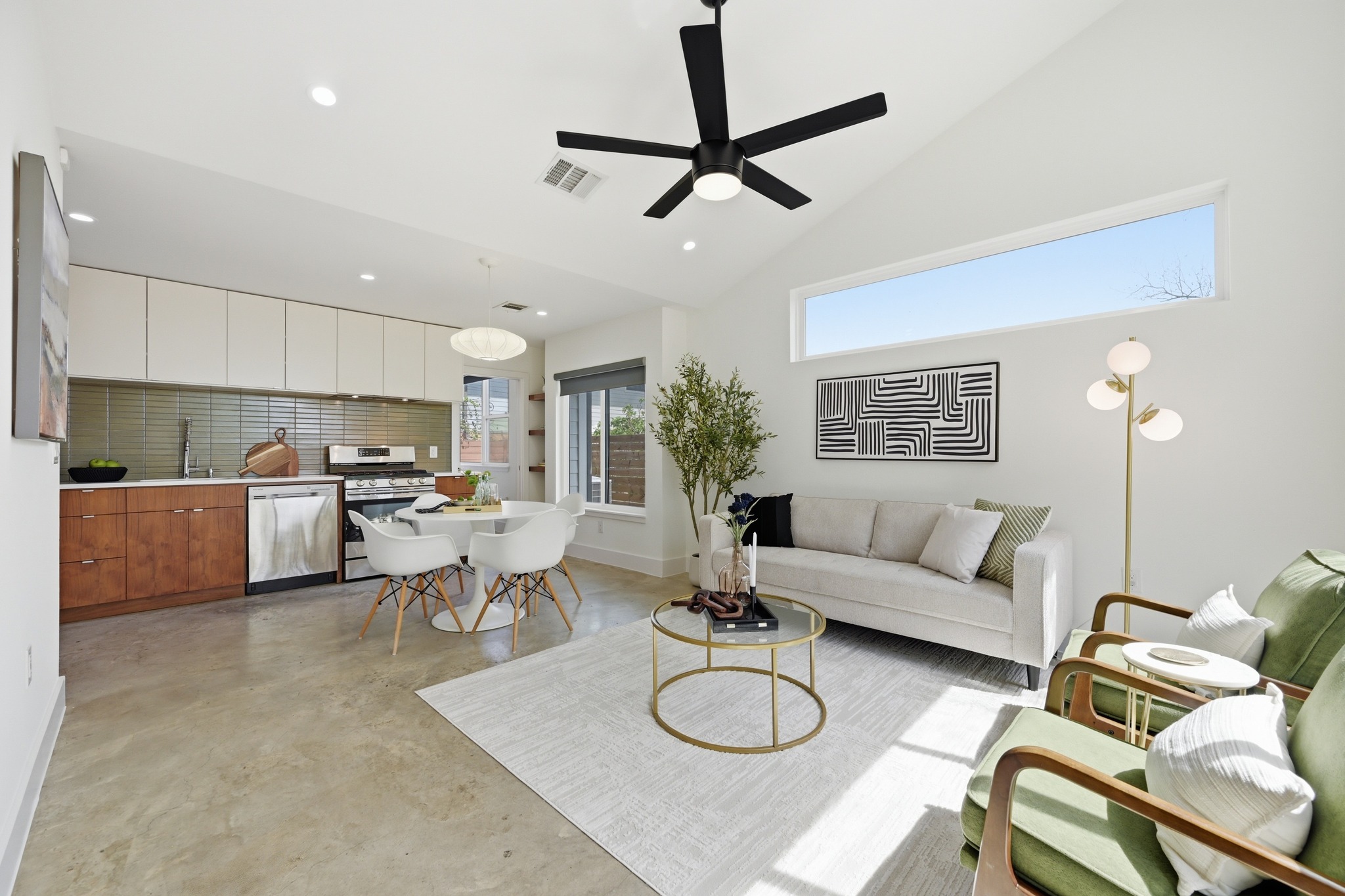 1805 Tillery Street Austin, TX 78721 - Photo 9 of 23 Living room featuring finished concrete floors, vaulted ceiling, ceiling fan, and recessed lighting
