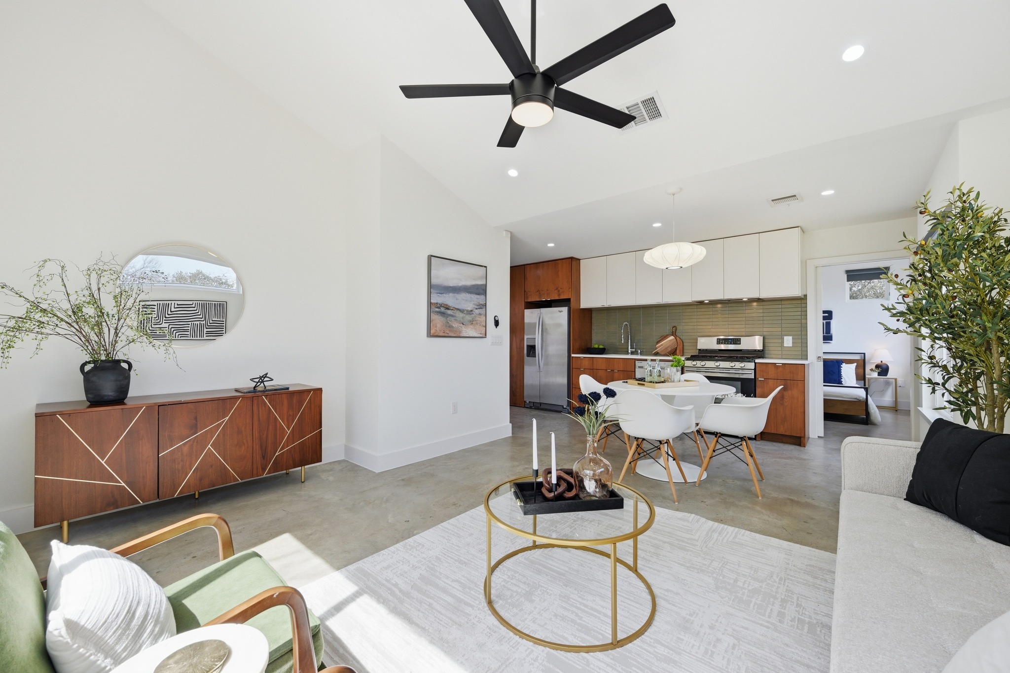 1805 Tillery Street Austin, TX 78721 - Photo 10 of 23 Living area with finished concrete floors, ceiling fan, vaulted ceiling, and recessed lighting