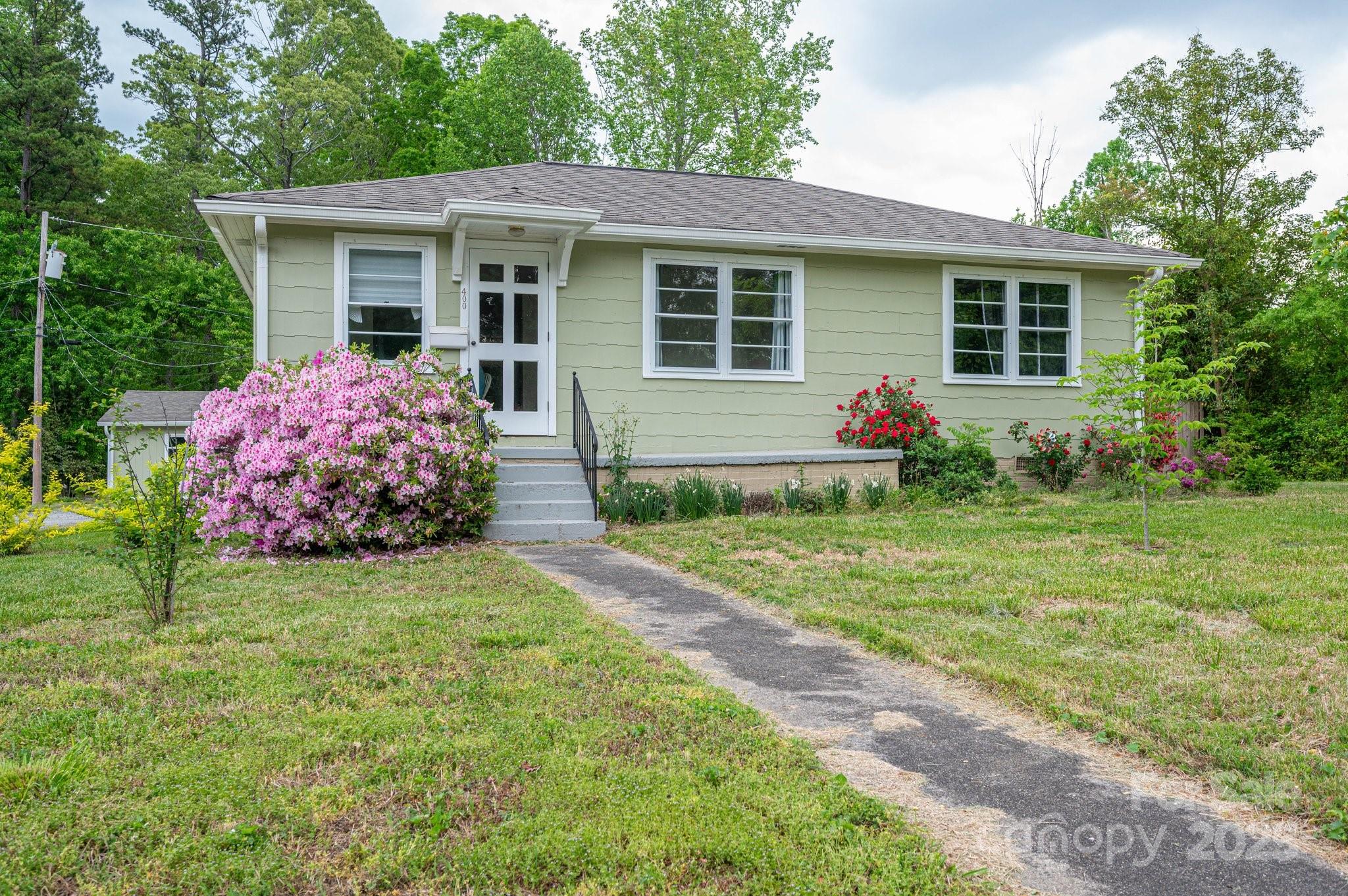 400 North Houser Street Cherryville, NC 28021 - Photo 1 of 26 a front view of a house with garden