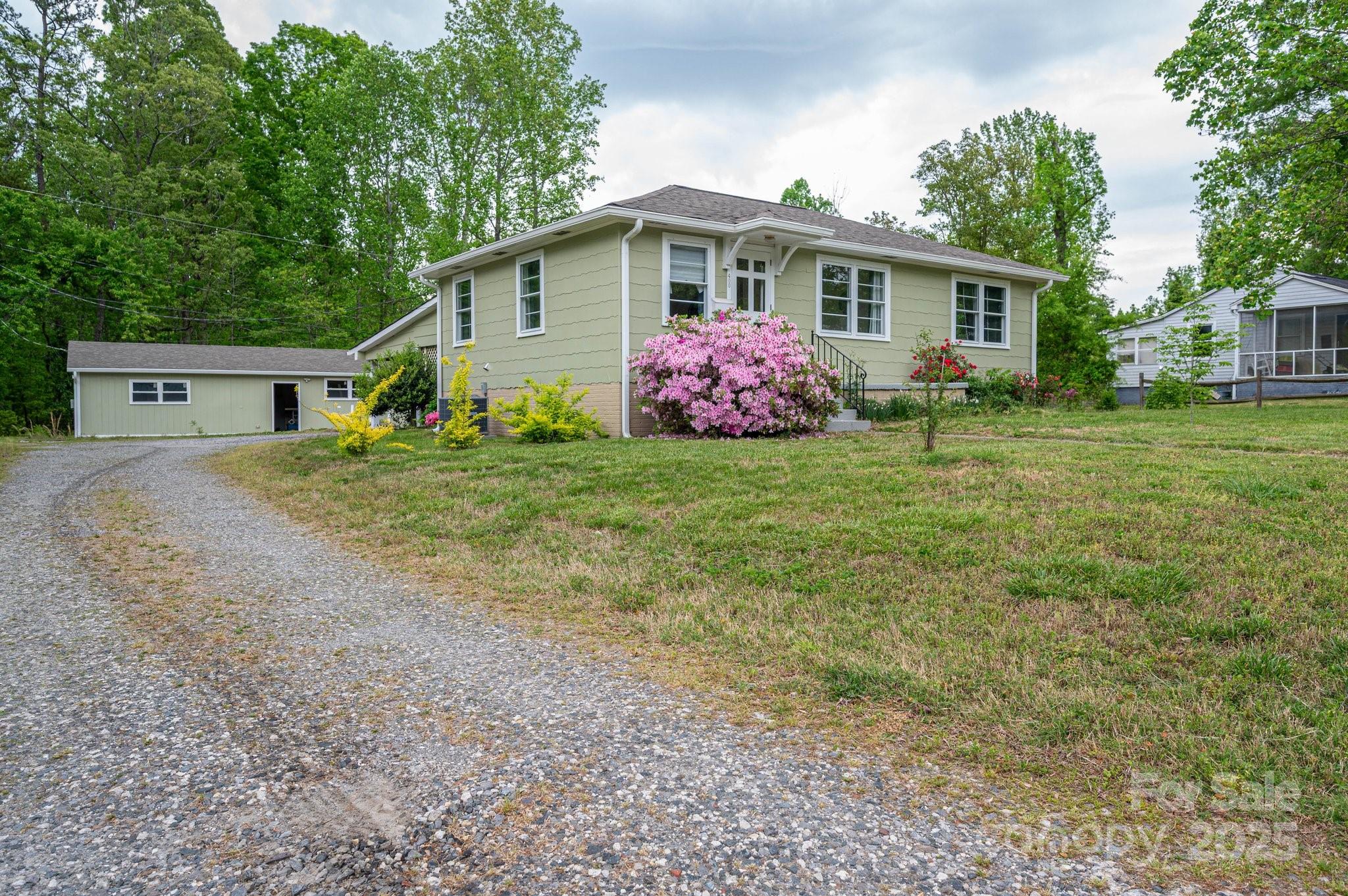 400 North Houser Street Cherryville, NC 28021 - Photo 19 of 26 a front view of a house with a garden