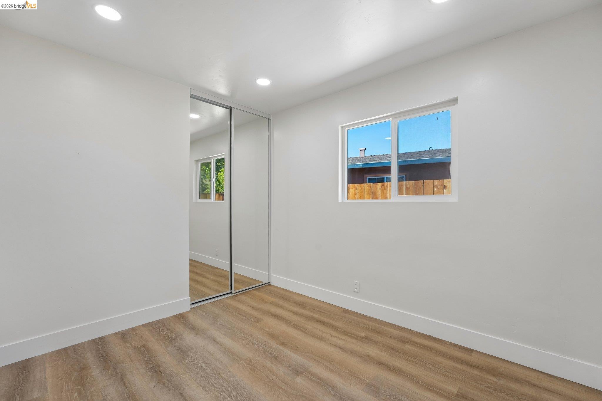 375 Senter Road San Jose, CA 95111 - Photo 36 of 80 an empty room with wooden floor and windows
