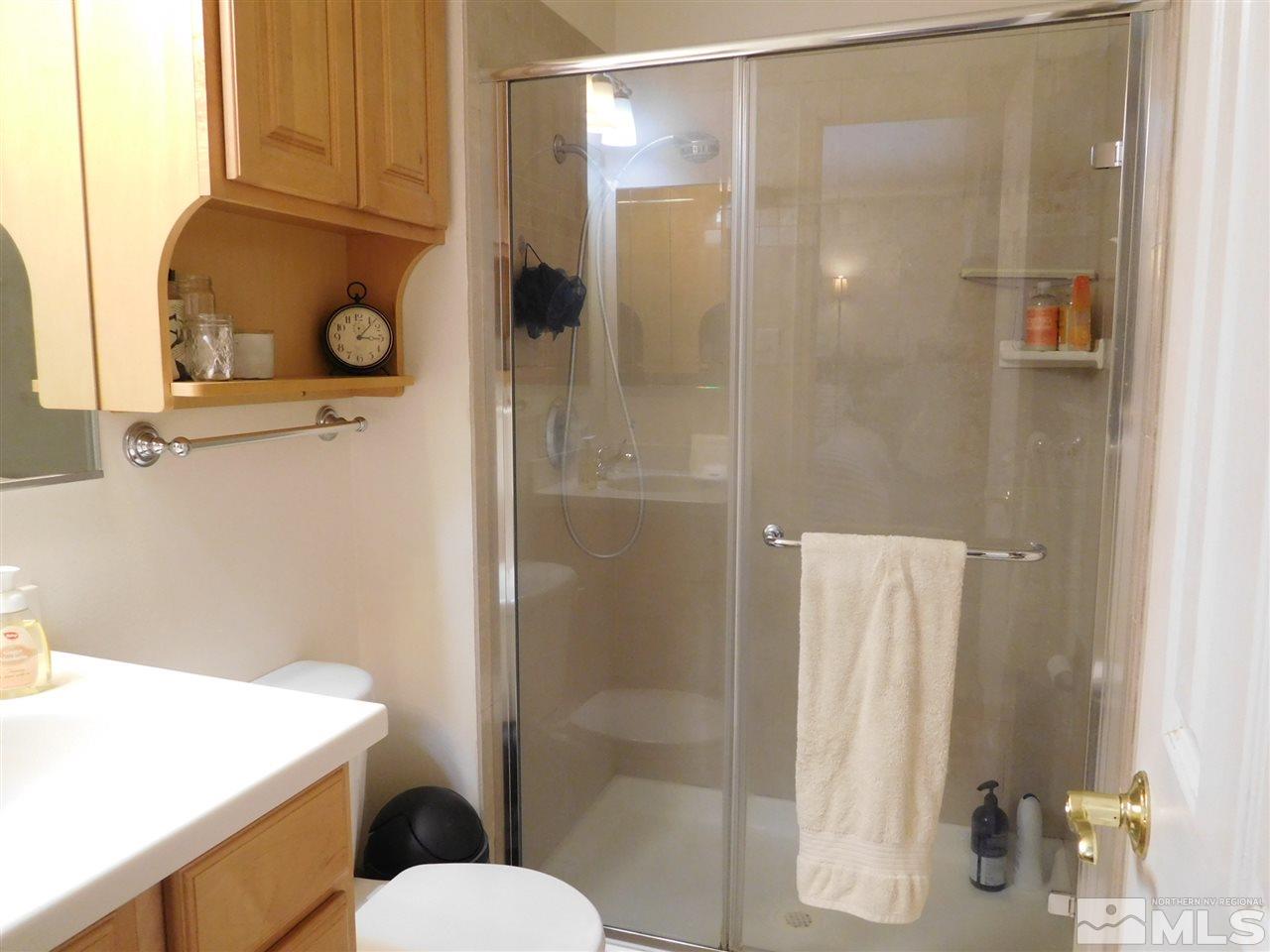 687 Ibis Lane Reno, NV 89503 - Photo 9 of 14 a bathroom with a sink and mirror with toilet