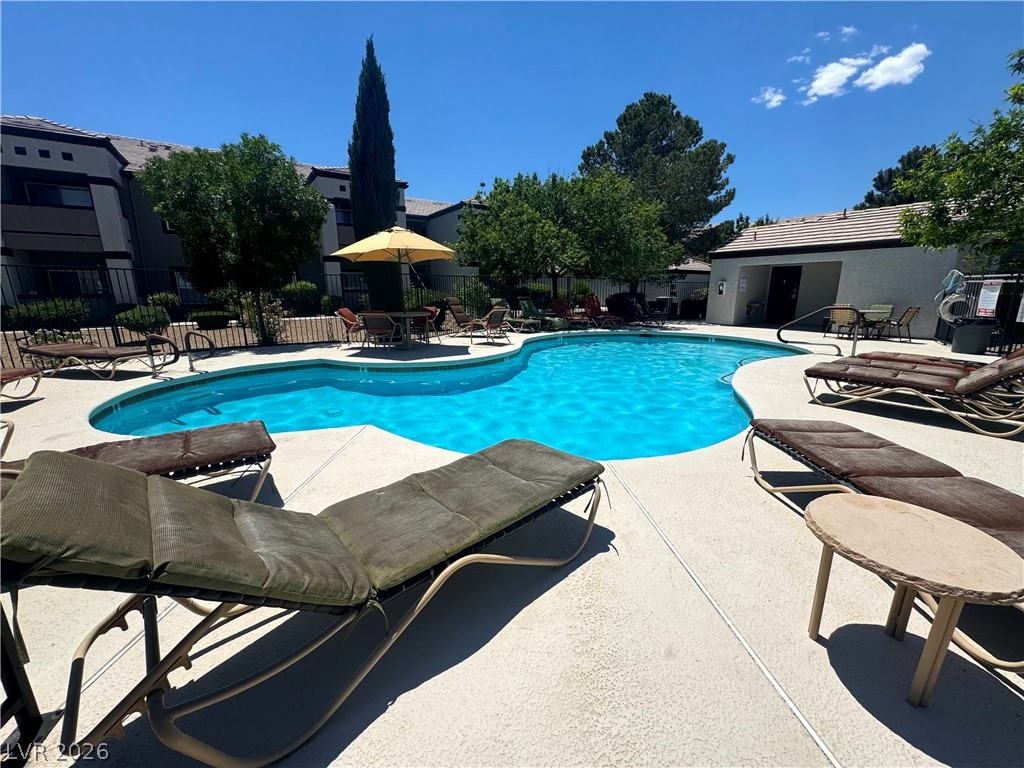 7255 West Sunset Road, Unit 2111 Las Vegas, NV 89113 - Photo 28 of 33 A refreshing pool awaits, surrounded by ample lounge seating for ultimate relaxation.