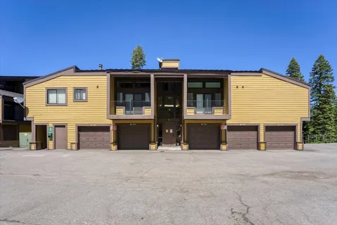 a front view of a house with large windows