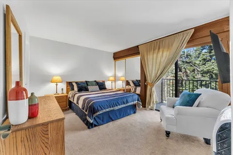 a living room with furniture a large window and a flat screen tv