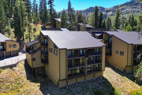 a view of a lush green field with mountains in the background