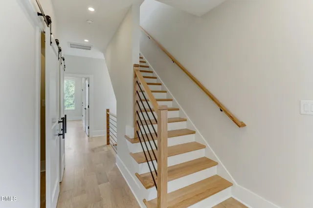 a view of entryway and hall with wooden floor