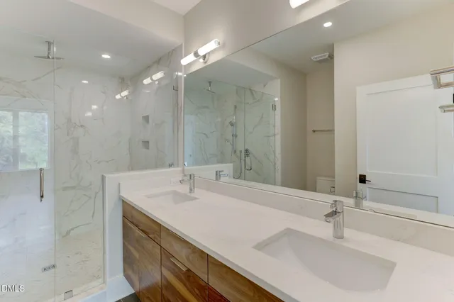 a bathroom with a sink double vanity and a mirror