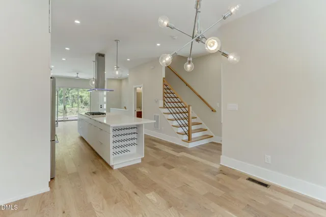 a view of kitchen and hall with wooden floor