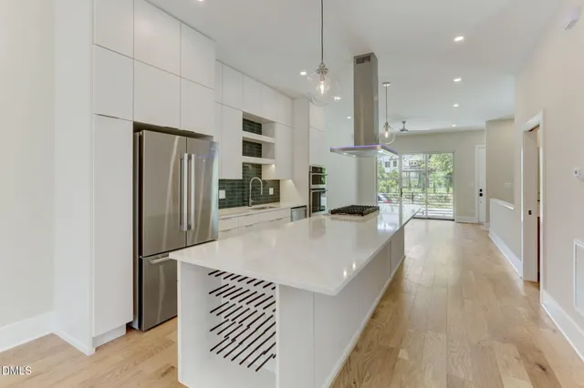 a kitchen with stainless steel appliances granite countertop a refrigerator oven a sink and a refrigerator