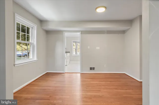 a kitchen with a refrigerator a stove a sink and a window