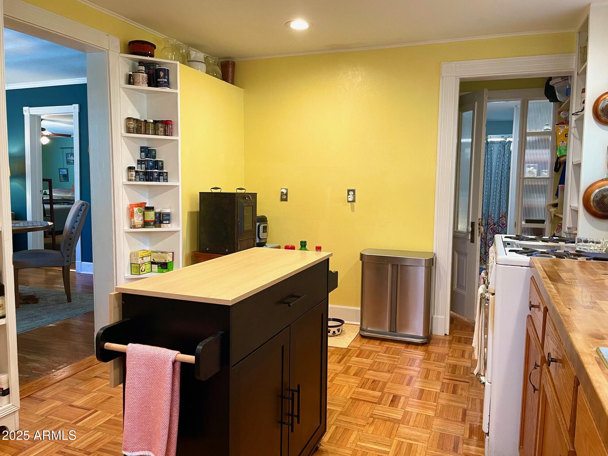 10 Locklin Avenue Bisbee, AZ 85603 - Photo 17 of 35 a view of a kitchen with fridge and wooden floor