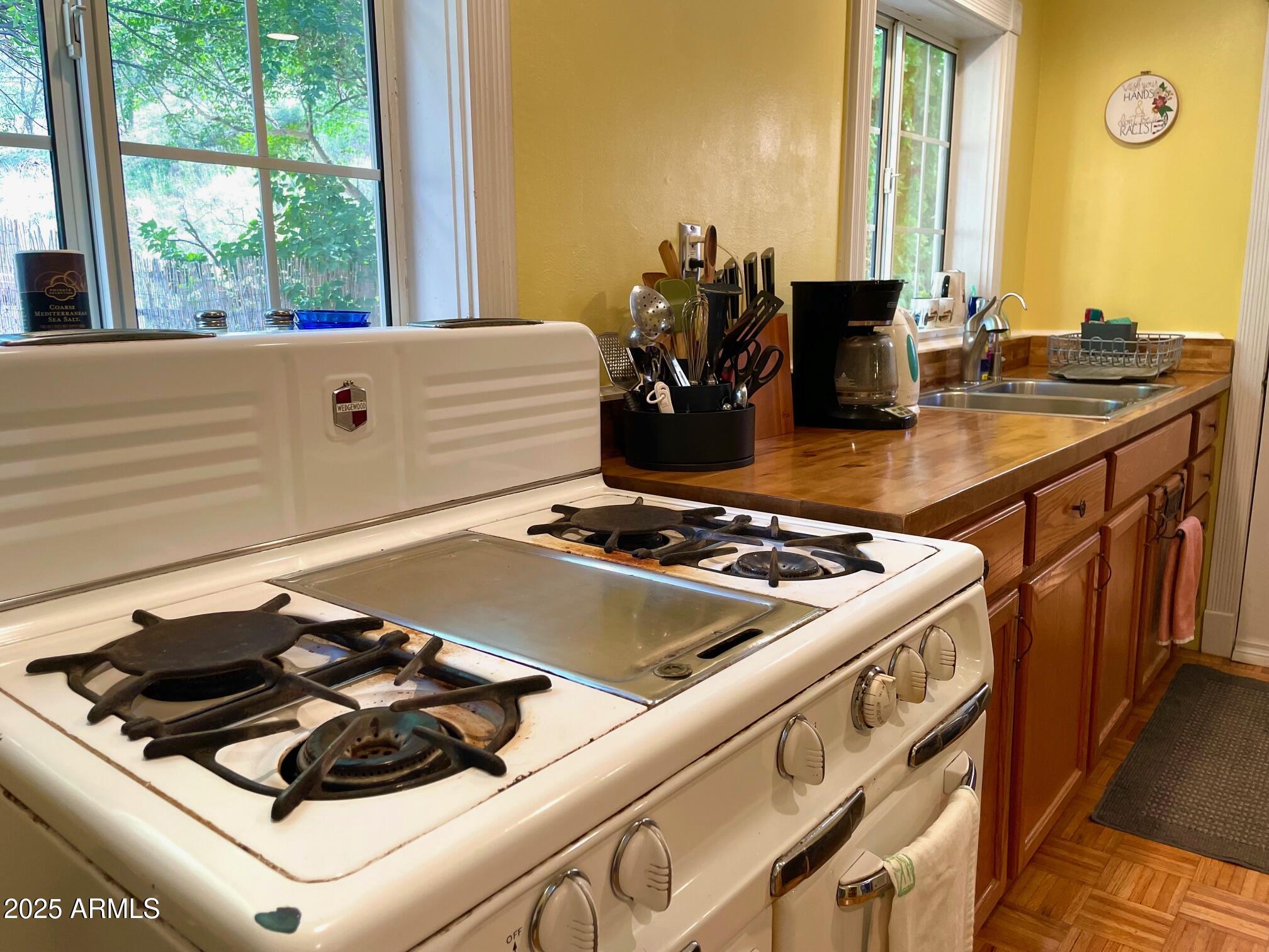 10 Locklin Avenue Bisbee, AZ 85603 - Photo 21 of 35 a stove top oven sitting next to a window